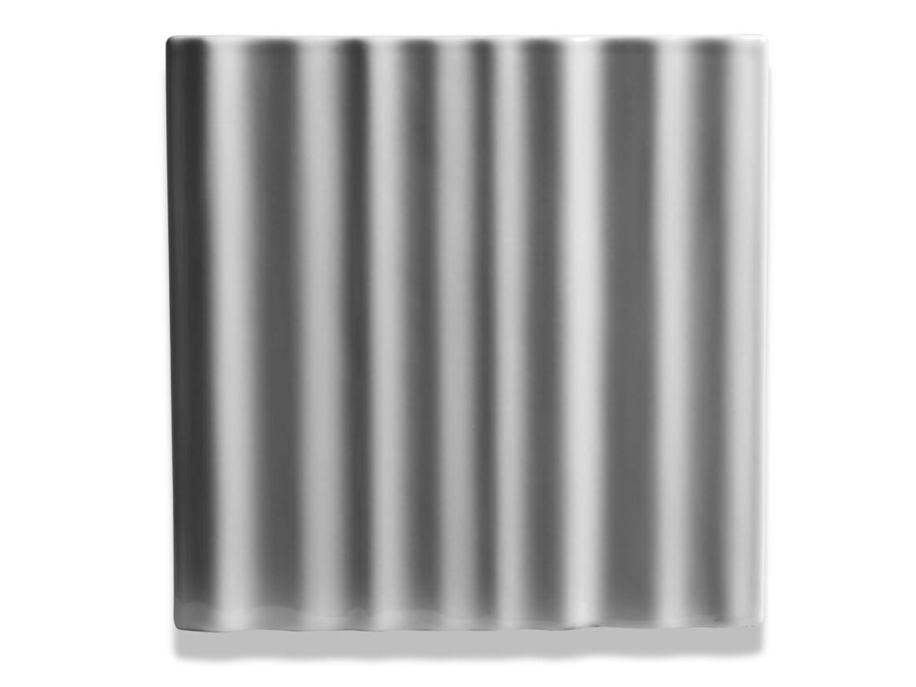 Fliese BASIL in der Farbe Grey. Das Bild zeigt eine einzelne BASIL-Fliese in einem hellgrauen Farbton. Die Datei ist ein Foto im JPEG-Format.